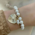 Freshwater pearl gold heart charmed bracelet